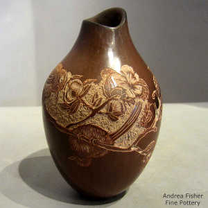 Sgraffito bird and flower design on a sienna jar with an organic opening