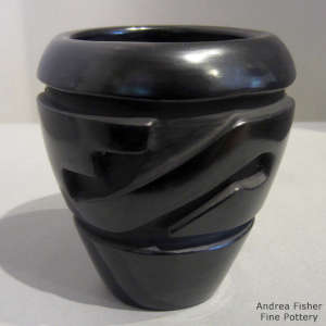 Geometric design carved into a black jar