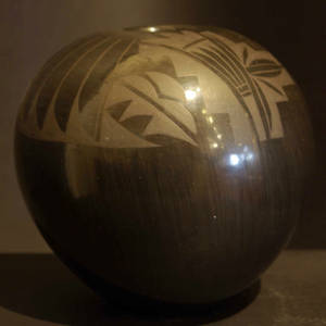 Feather, wing and geometric designs on a black on black seedpot