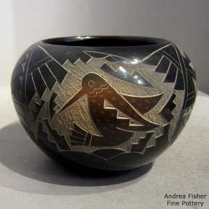 Sienna spots and sgraffito hummingbird, cloud, kokopelli, feather and geometric design on a black seed pot