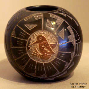 2 sienna sgraffito medallions plus geometric design on a black seed pot