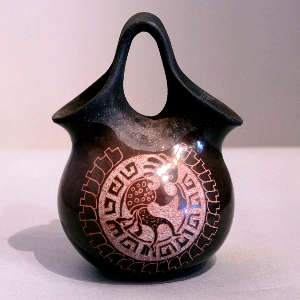 Sgraffito kokopelli and geometric design on a sienna wedding vase with an unpolished handle