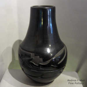 Black jar carved with an avanyu design
