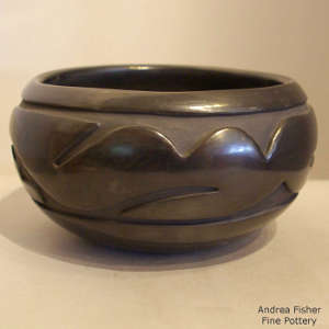 Avanyu design carved into a polished black jar