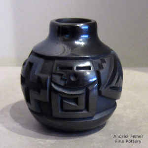 Yei and geometric design carved into a black on black jar