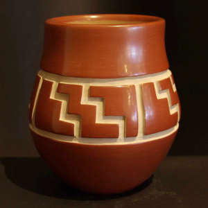 Kiva step and geometric design carved into a red jar