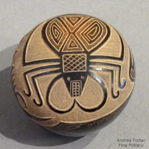 Sgraffito scorpion and geometric design on a black seed pot with a sienna spot