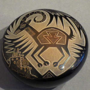 Sgraffito antelope and traditional geometric designs with sienna spots on a black seedpot