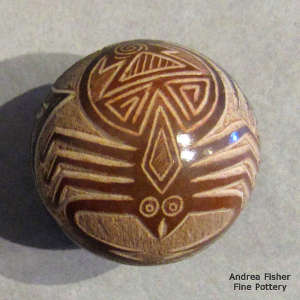 Sgraffito scorpion and geometric design and sienna spot on a black seed pot