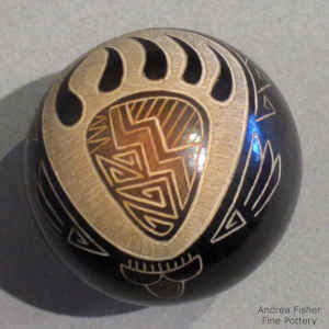 Sgraffito bear paw, rain cloud and geometric design on a miniature black seed pot with a sienna spot