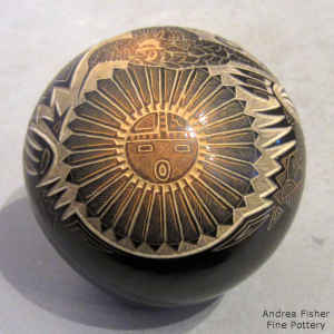 Sgraffito feathers, sun kachina, hummingbird and geometric design on a miniature black seed pot with a sienna spot