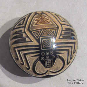 Sgraffito spider, feather and geometric design on a miniature black seed pot with sienna spots
