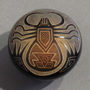 Sgraffito spider and traditional geometric designs with sienna spots on a black seedpot