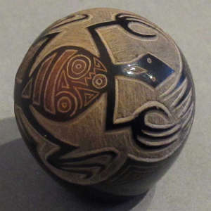 Sgraffito lizard and geometric designs on a black seedpot with sienna spot