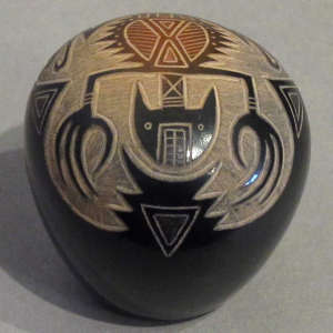 Sgraffito lizard and geometric designs on a black seedpot with sienna spot