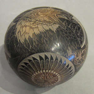 Sgraffito eagle with contemporary and traditional geometric design on a black seedpot with sienna spots