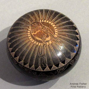 Sgraffito hummingbird, feather and geometric design on a black seed pot