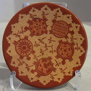 Sgraffito turtle, dragonfly and geometric designs on a polychrome plate