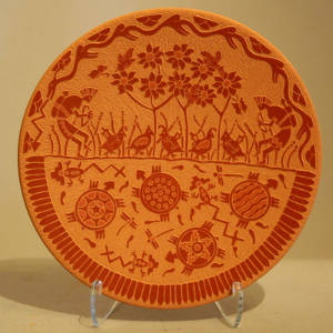 Sgraffito turtle, quail, floral, hunter and geometric design on a red plate
