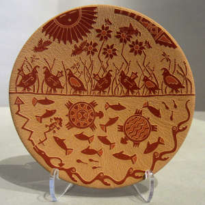 Sgraffito nature design on a red plate