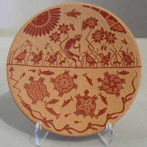 Sgraffito turtle, quail and flute player design on a red plate