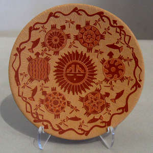 Sgraffito turtle, double avanyu and sun-face design on a red plate
