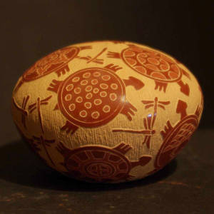 Sgraffito turtle and dragonfly designs on a red seedpot