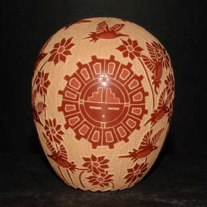 Sgraffito sun face, flower and hummingbird design on a red seedpot