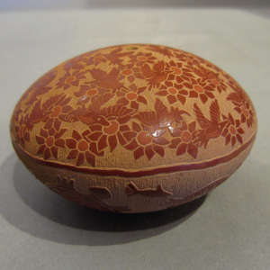 Bird and floral sgraffito design above and underwater sgraffito scene below on a red seedpot