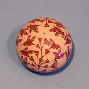 Sgraffito hummingbird and floral motif on a red seed pot
