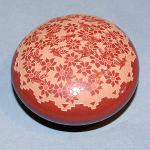 Sgraffito hummingbird and flower design on a red seed pot