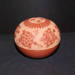 Sgraffito turtle, dragonfly, butterfly and geometric design on a red seed pot