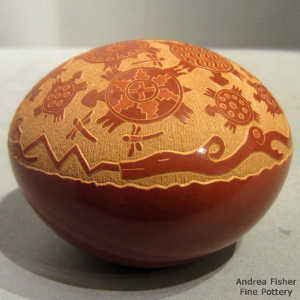 Sgraffito avanyu, dragonfly, turtle and geometric design on a red seed pot