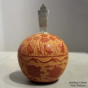 Sgraffito quail, turtle, flower, avanyu, fish and geometric design on a red seed pot with a Shifting Sands design sterling silver lid