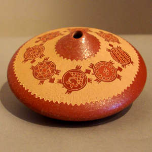 Sgraffito turtle and geometric design on a red seed pot