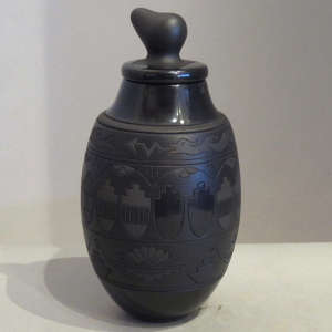 Avanyu, clouds, kiva step and geometric designs carved into a black on black jar