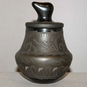 Sgraffito and painted avanyu, cloud and geometric design on a lidded black jar