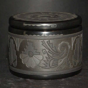 Carved geometric designs on a black on black on black jar with a micaceous black slip added