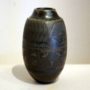 Black jar with five different black slips applied to the carved surface