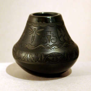 Avanyu, dragonfly and geometric design lightly carved into a black on black jar