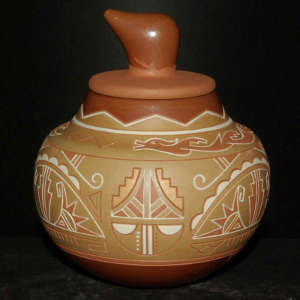 Avanyu and geometric design lightly carved in a lidded polychrome jar