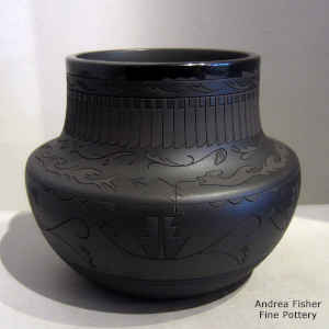 Black on black on black jar with sgraffito avanyu, feather and geometric design