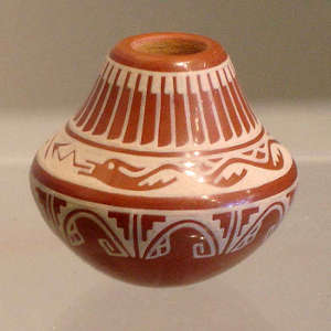 White avanyu, feather and geometric design on a miniature red jar