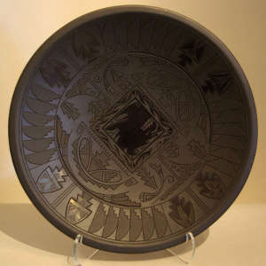 Geometric design carved into a black on black plate