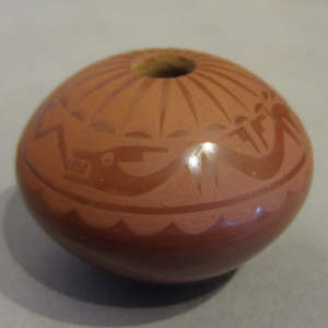 Avanyu and geometric designs on a red on red seedpot