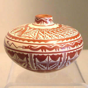Avanyu and geometric design painted on a red and white seedpot