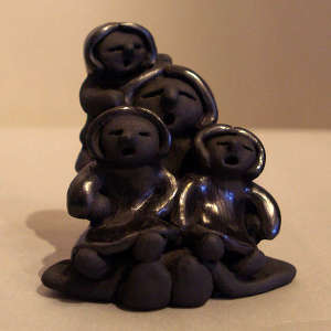Three children on a black storyteller figure