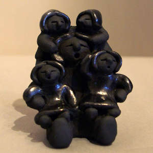 Four children on a black storyteller figure