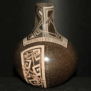 Sgraffito dragonfly and geometric designs on a brown vase