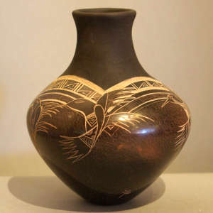 Sgraffito hummingbird and geometric design on a brown vase with sienna spots